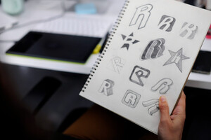 Creative team developing memorable brand identity elements including logos, colors, and brand guidelines for client project